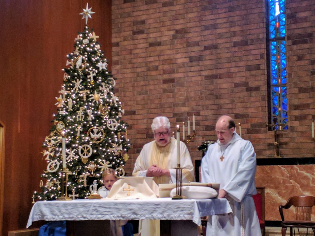 Acolyte, Pastor, and Deacon at the Alter at Christmas